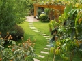 A stone walkway winding its way through a tranquil garden